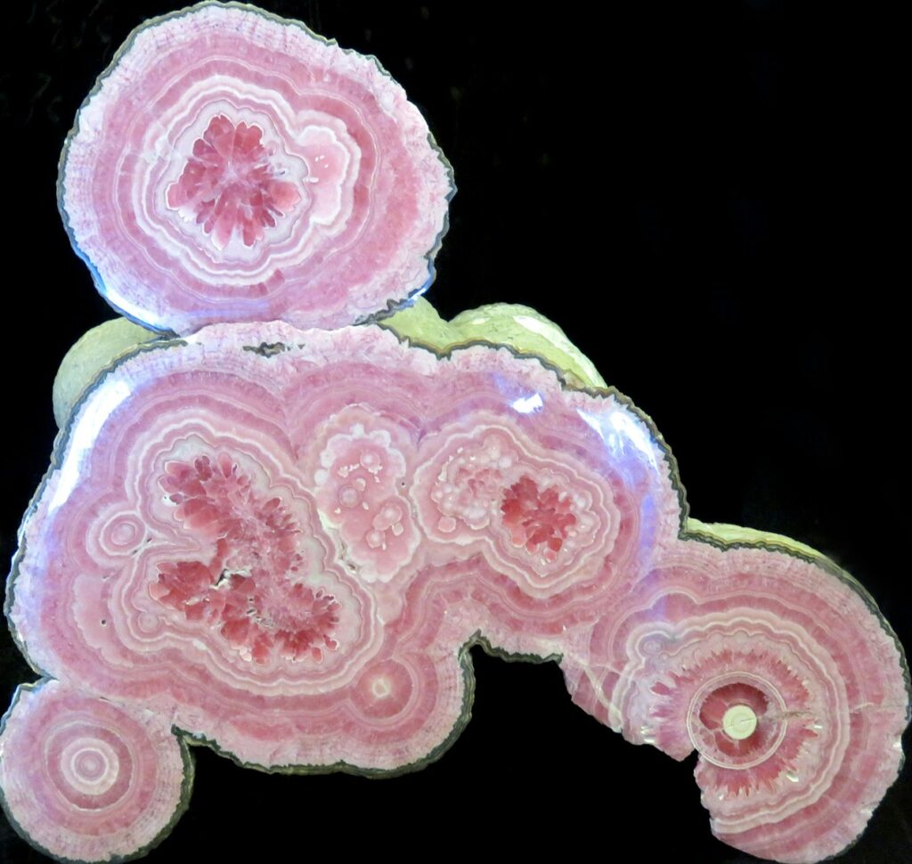 a close-up of the inside of geodes with pink crystals